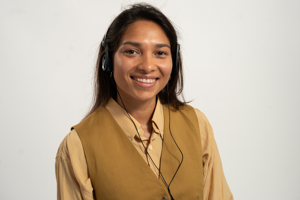 Smiling Woman Wearing Headset on White Background